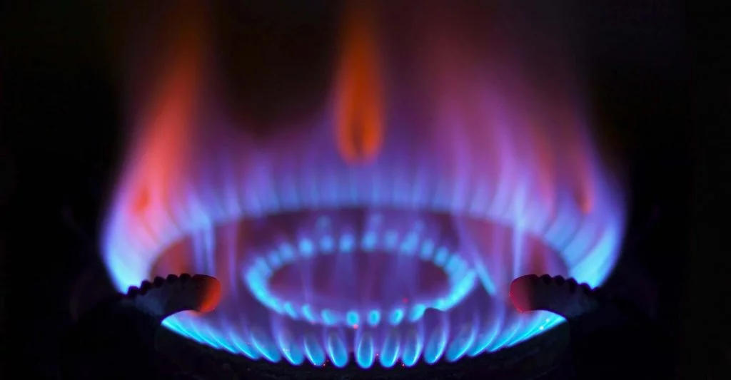 Closeup of gas stove burner in darkness